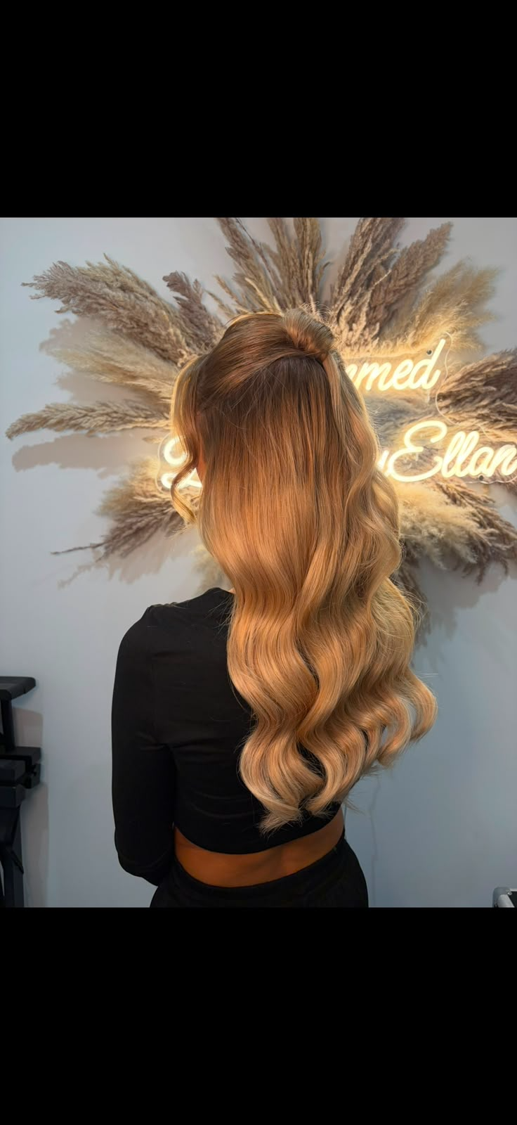 Half-up ponytail with long bouncy waves