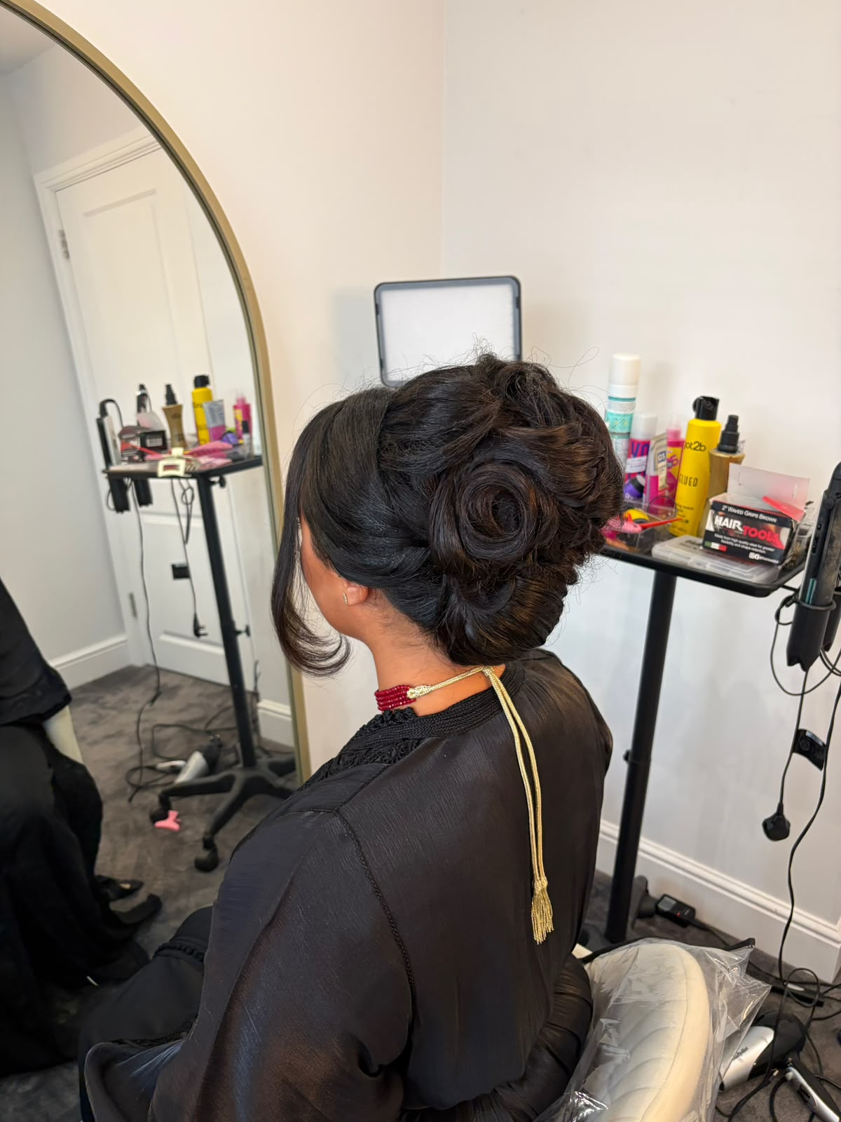 Dark rolled updo with sculpted curls