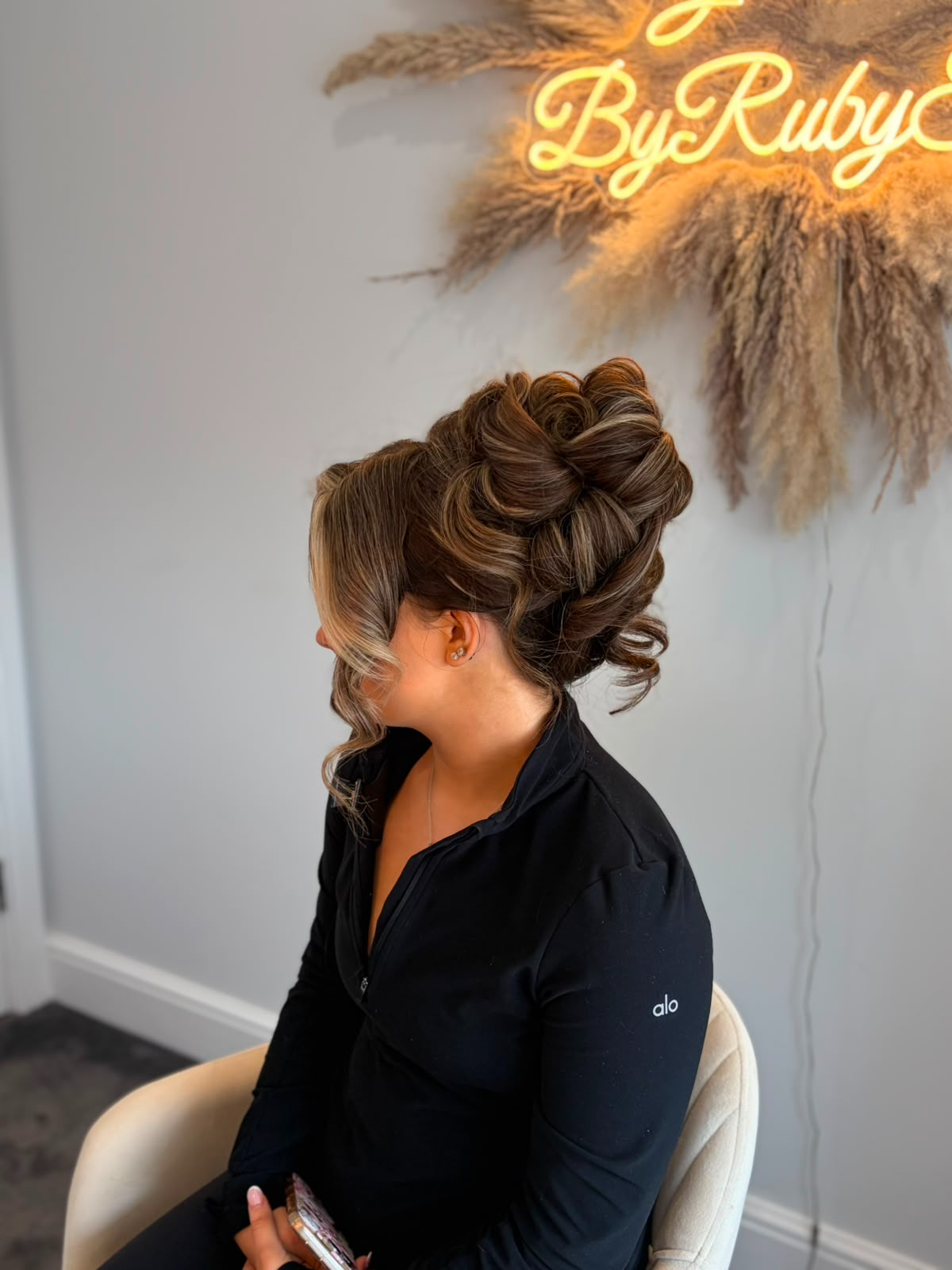 Curled brunette high updo styled in the salon